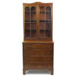 Georgian style mahogany bookcase on stand with brushing slide and four drawers on bracket feet, 82.