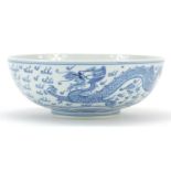 Chinese blue and white porcelain bowl hand painted with a dragon and phoenix amongst clouds, six