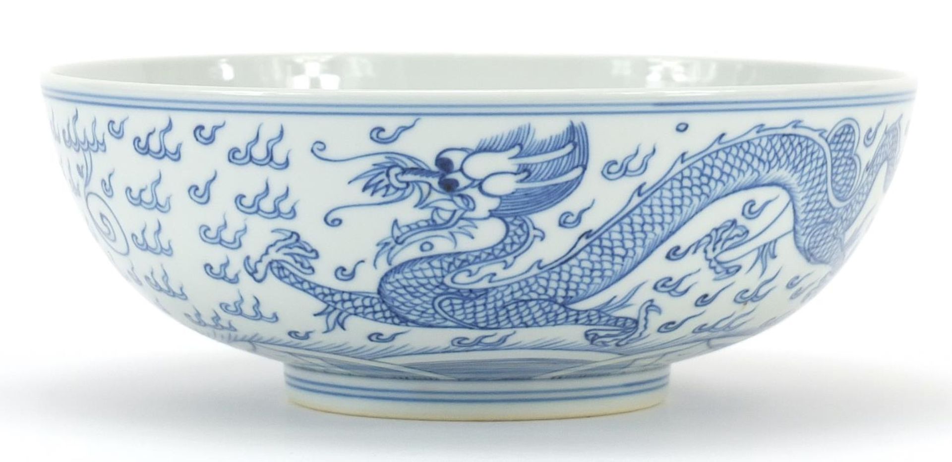 Chinese blue and white porcelain bowl hand painted with a dragon and phoenix amongst clouds, six