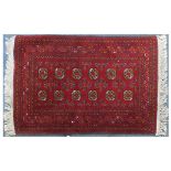 Red ground rug having an all over geometric design, 135cm x 80cm