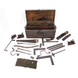 Collection of vintage woodworking tools housed in an antique pine chest including wood planes,