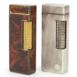 Two Dunhill pocket lighters including a faux tortoiseshell example, each 6.5cm high