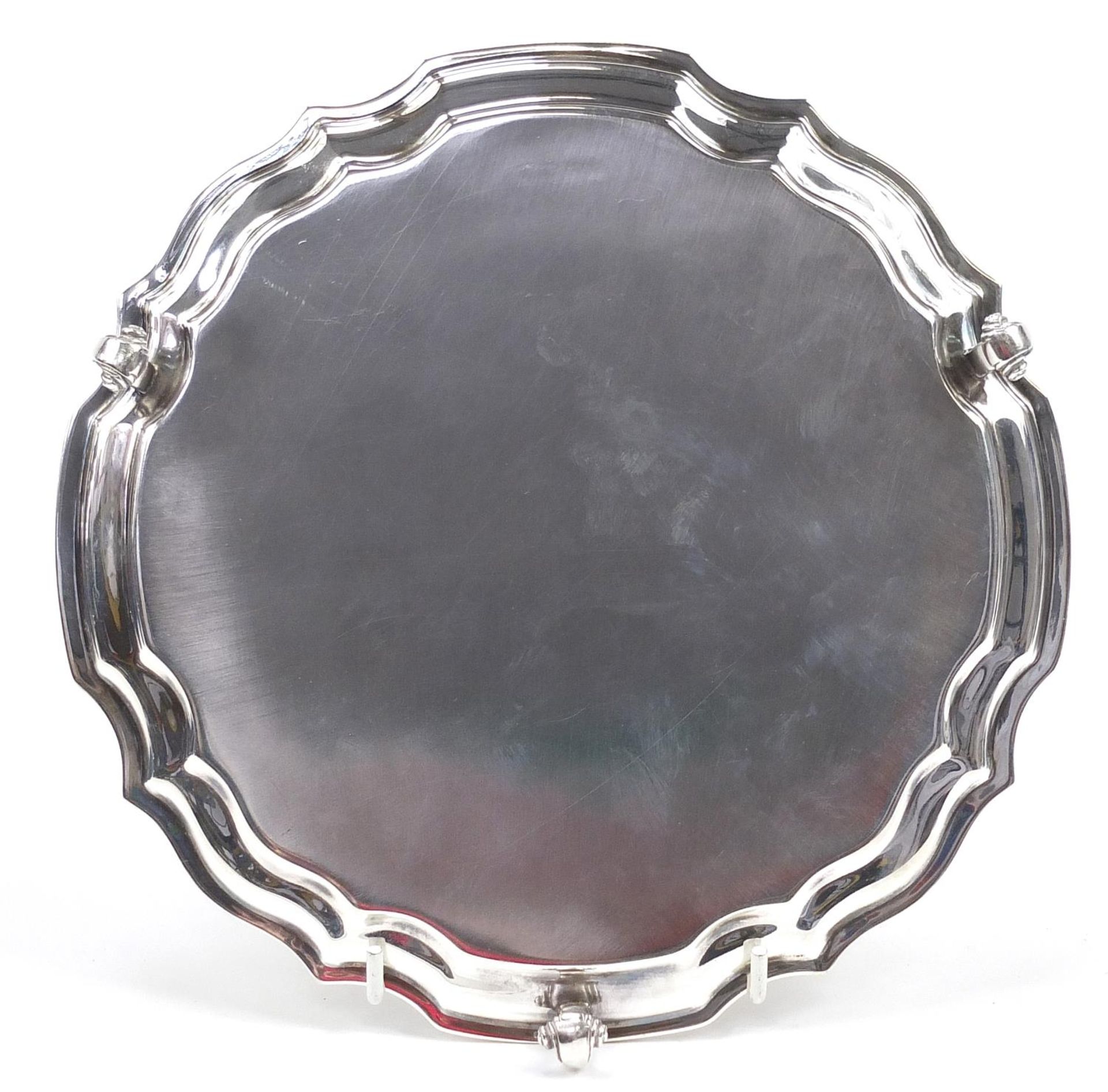 Elkington & Co Ltd, Elizabeth II circular silver salver raised on three scrolled feet with - Image 5 of 5