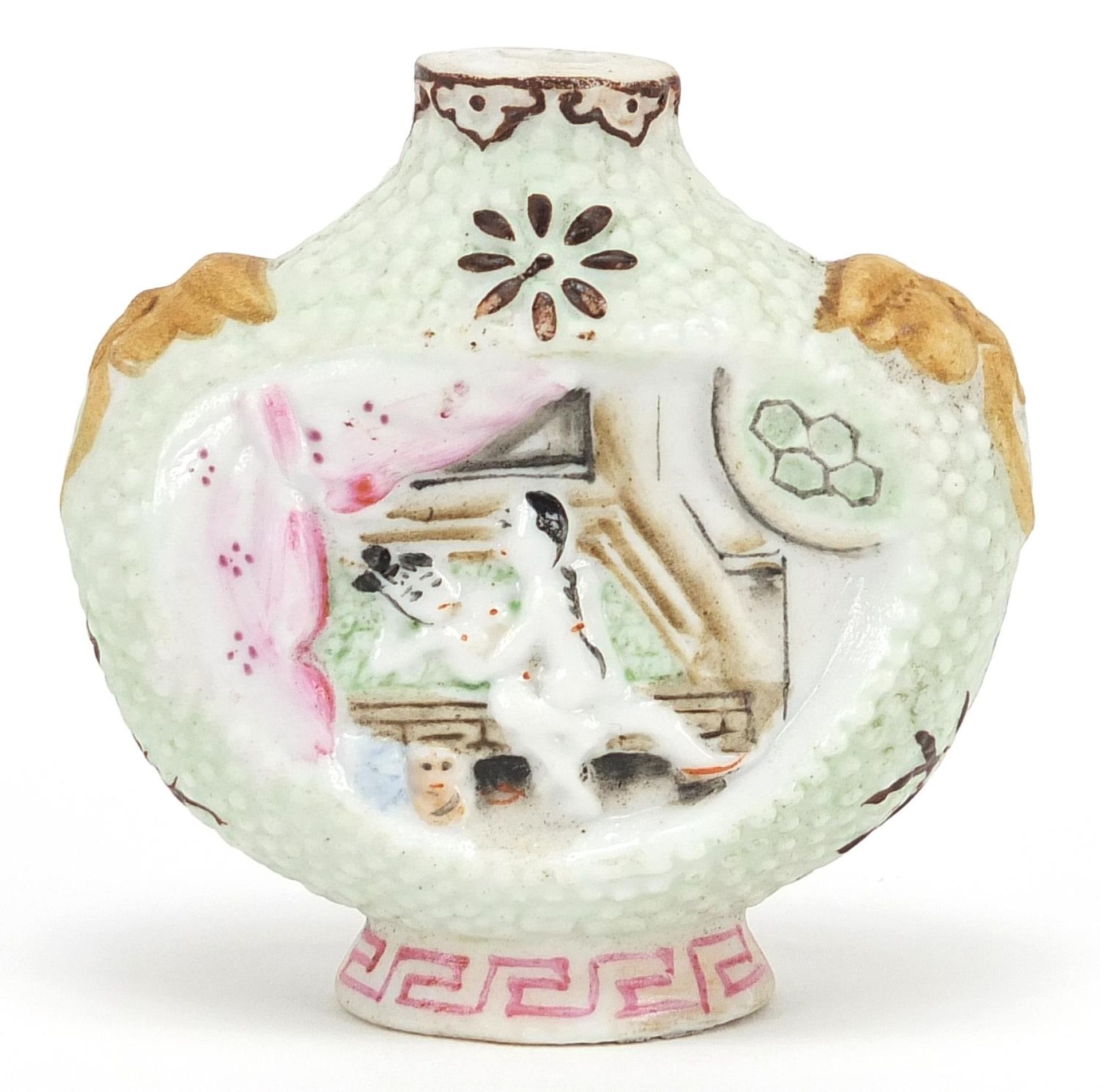 Chinese porcelain snuff bottle decorated in relief with erotic scenes, 6cm high
