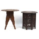 Two Indian carved wood folding occasional tables, one profusely carved with fruit on a vine, 60cm