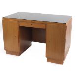 Manner of Heals, Art Deco oak desk with lift of glass top and two doors enclosing drawers and