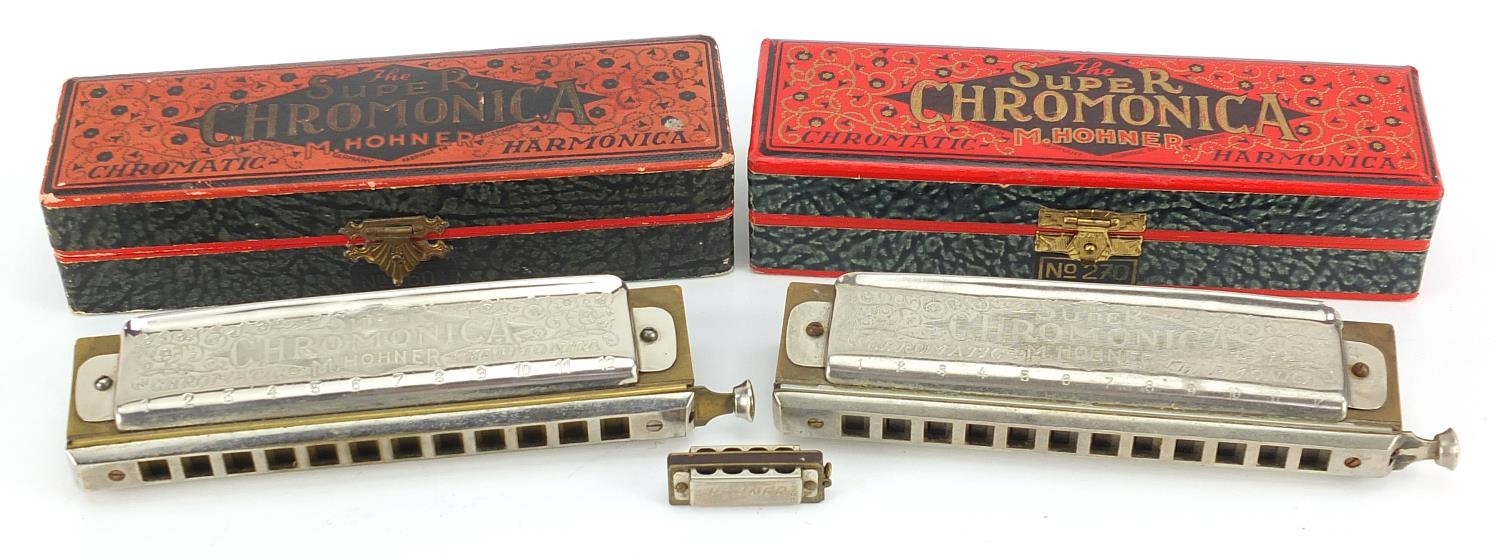 Two M Hohner Super Chromonica harmonicas with boxes