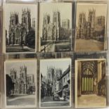Collection of topographical and social history postcards arranged in an album, some black and
