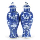 Pair of Chinese blue and white porcelain baluster vases and covers hand painted with prunus flowers,