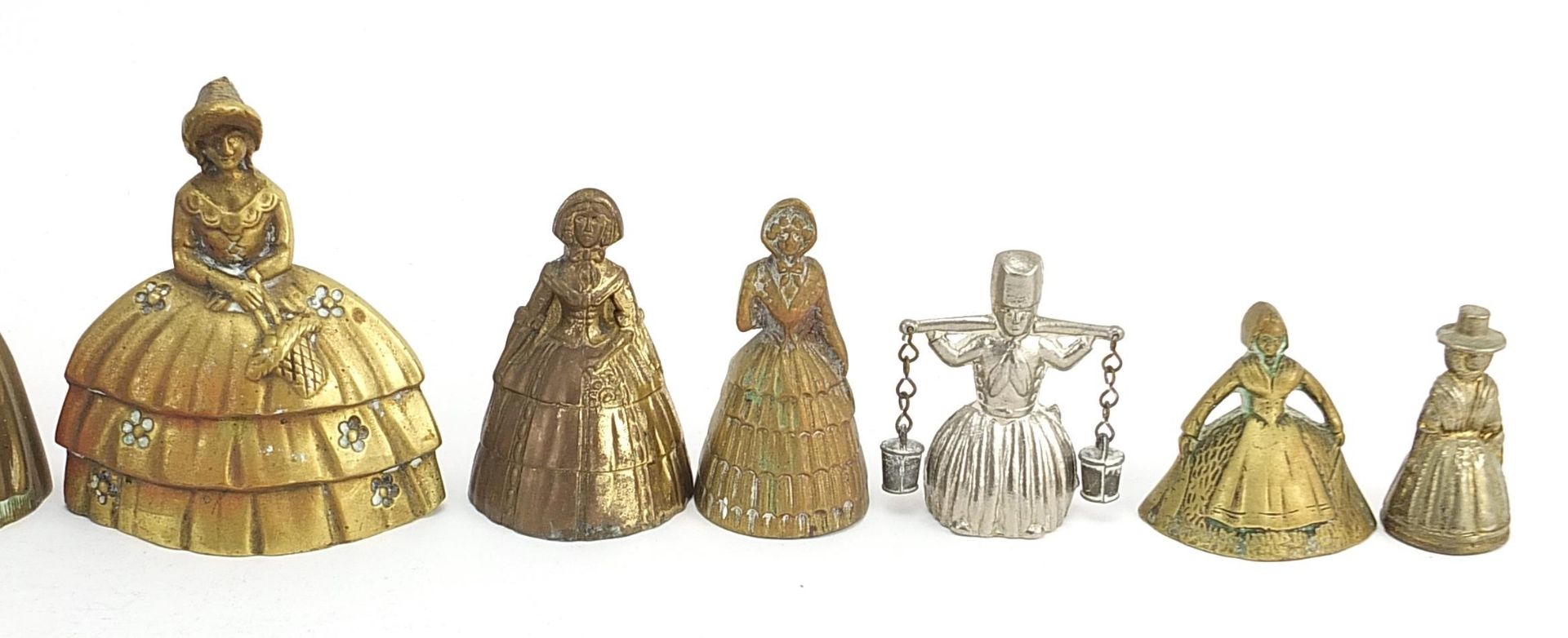 Twelve brass and white metal Crinoline Lady table bells, the largest 10.2cm high - Image 3 of 6