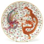 Chinese porcelain dish hand painted in the famille rose palette with a phoenix and dragon chasing
