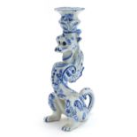 Faience glazed candlestick in the form of a dragon, 24.5cm high