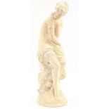 Classical plaster sculpture of a semi nude female seated on a rock, 65cm high
