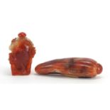 Chinese carnelian snuff bottle carved with flowers and a carving of a fruit with inscribed paper