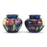 Pair of Moorcroft Pottery vases hand painted with fruits, each 7cm high