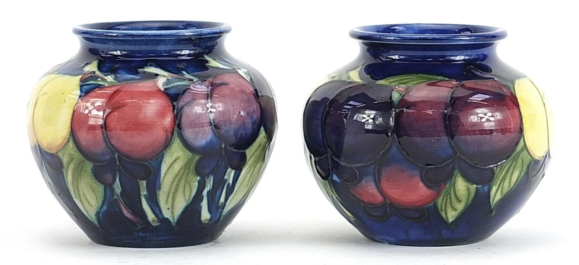 Pair of Moorcroft Pottery vases hand painted with fruits, each 7cm high