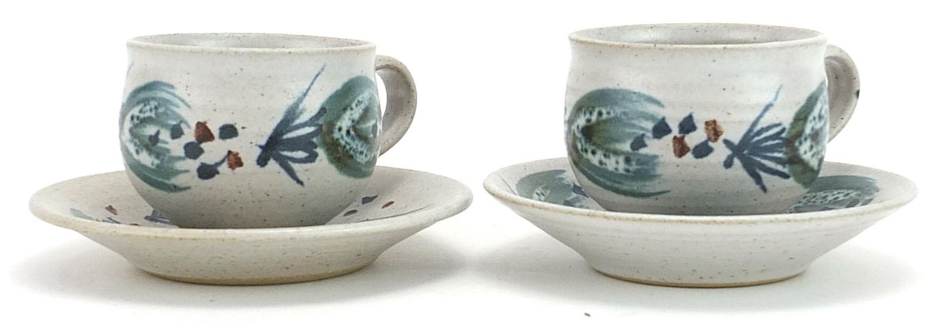 Marianne de Trey, pair of studio pottery cups and saucers hand painted with stylised motifs, - Image 2 of 3