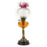 Victorian brass oil lamp with amber glass reservoir and cranberry glass shade, 63cm high