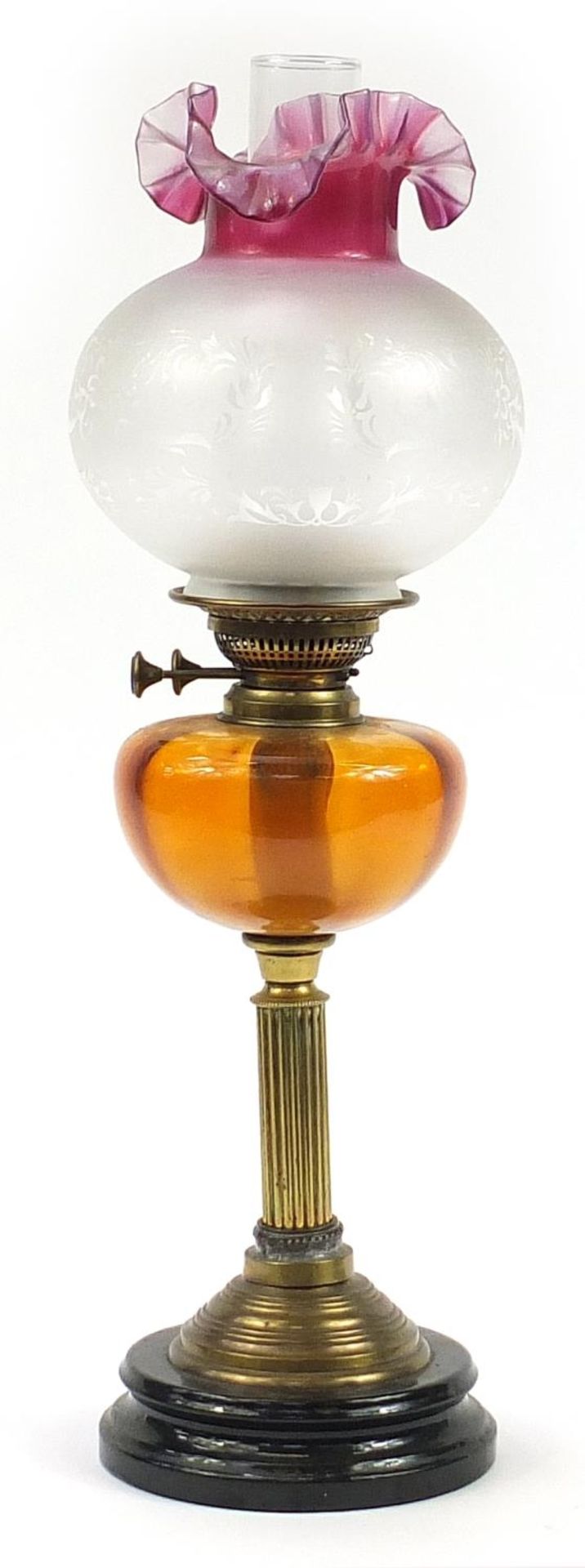 Victorian brass oil lamp with amber glass reservoir and cranberry glass shade, 63cm high