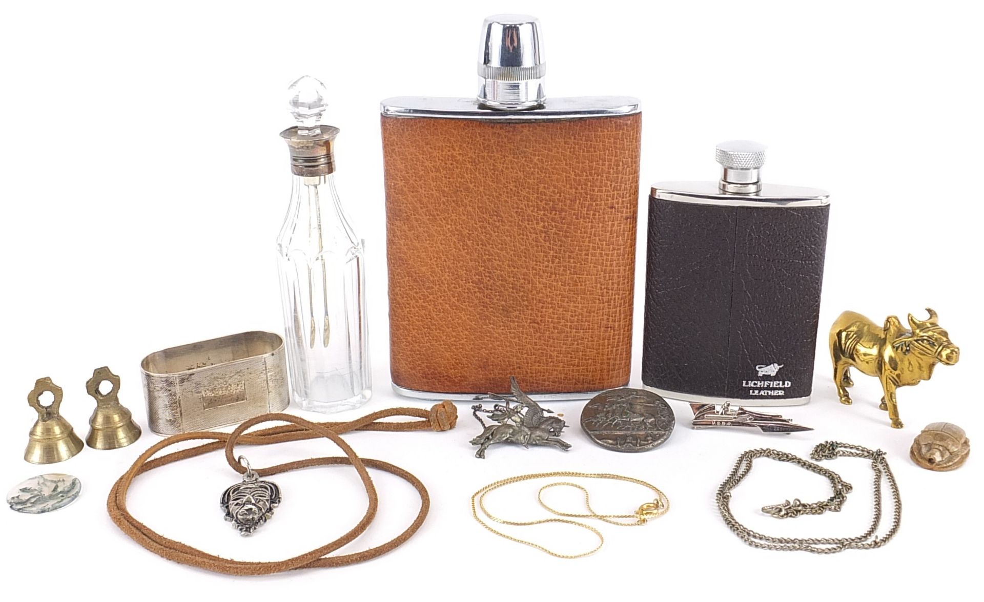 Objects including silver napkin ring, silver mounted scent bottle and hip flasks, the largest 15cm