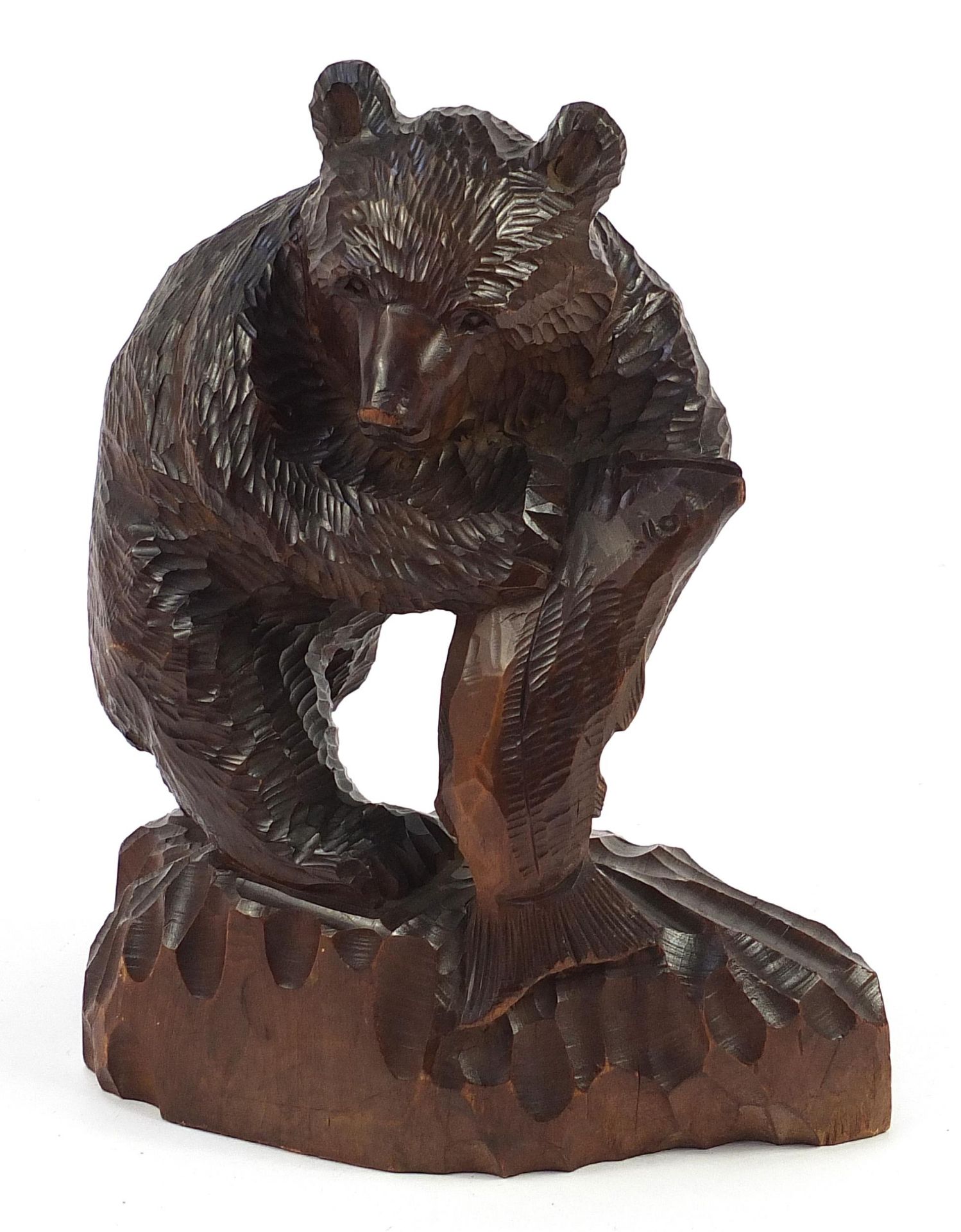 Large Black Forest carving of a bear with fish, incised Chinese character marks to the reverse, 31.