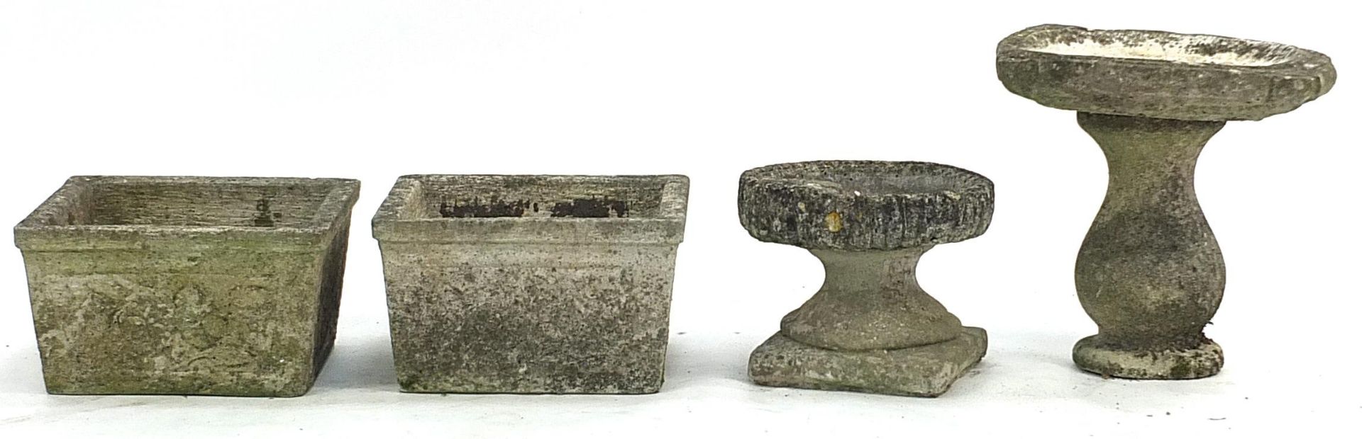 Pair of garden stoneware planters and two birdbaths, the largest 35cm high