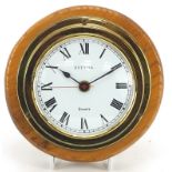 Estyma, brass ships bulk head design clock with Roman numerals, mounted on an oak back, 18cm in dia