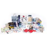 Collection of Swatch wristwatch memorabilia including wristwatch stands, hot drinks cup, badges,