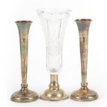 Pair of silver trumpet bud vases and a cut glass vase with silver base, the pair by A T Cannon