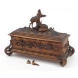 Black Forest table casket with silk button back interior carved with two deer and foliage, 29.5cm