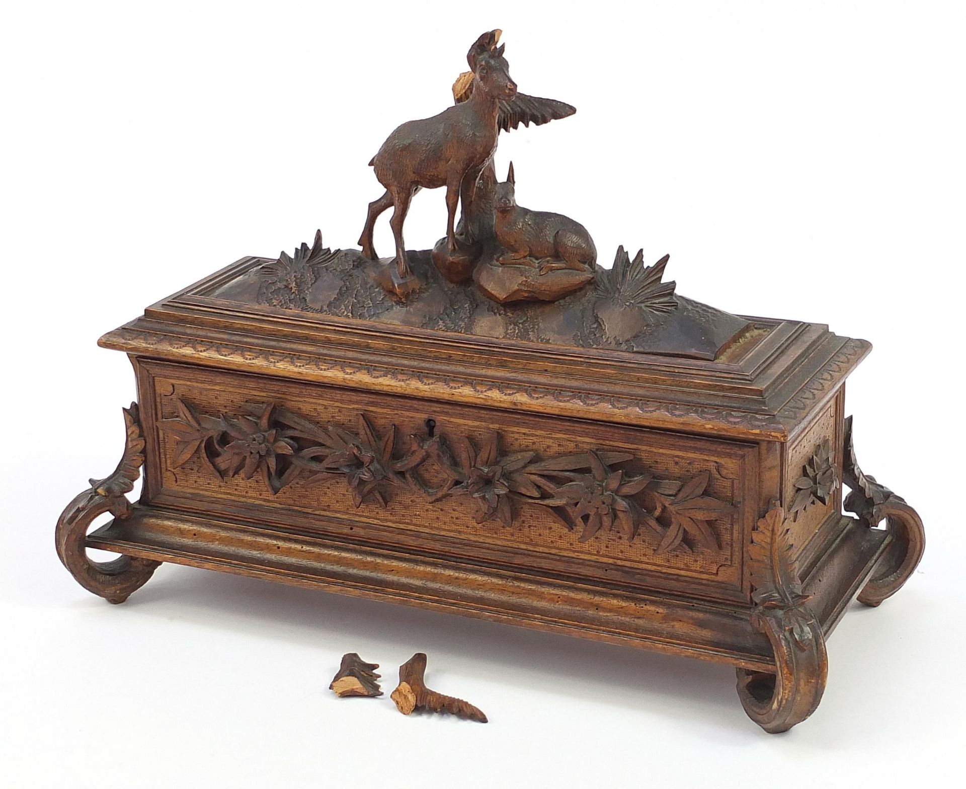 Black Forest table casket with silk button back interior carved with two deer and foliage, 29.5cm