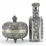 Middle Eastern silver bottle case with glass bottle and a circular silver box and cover embossed