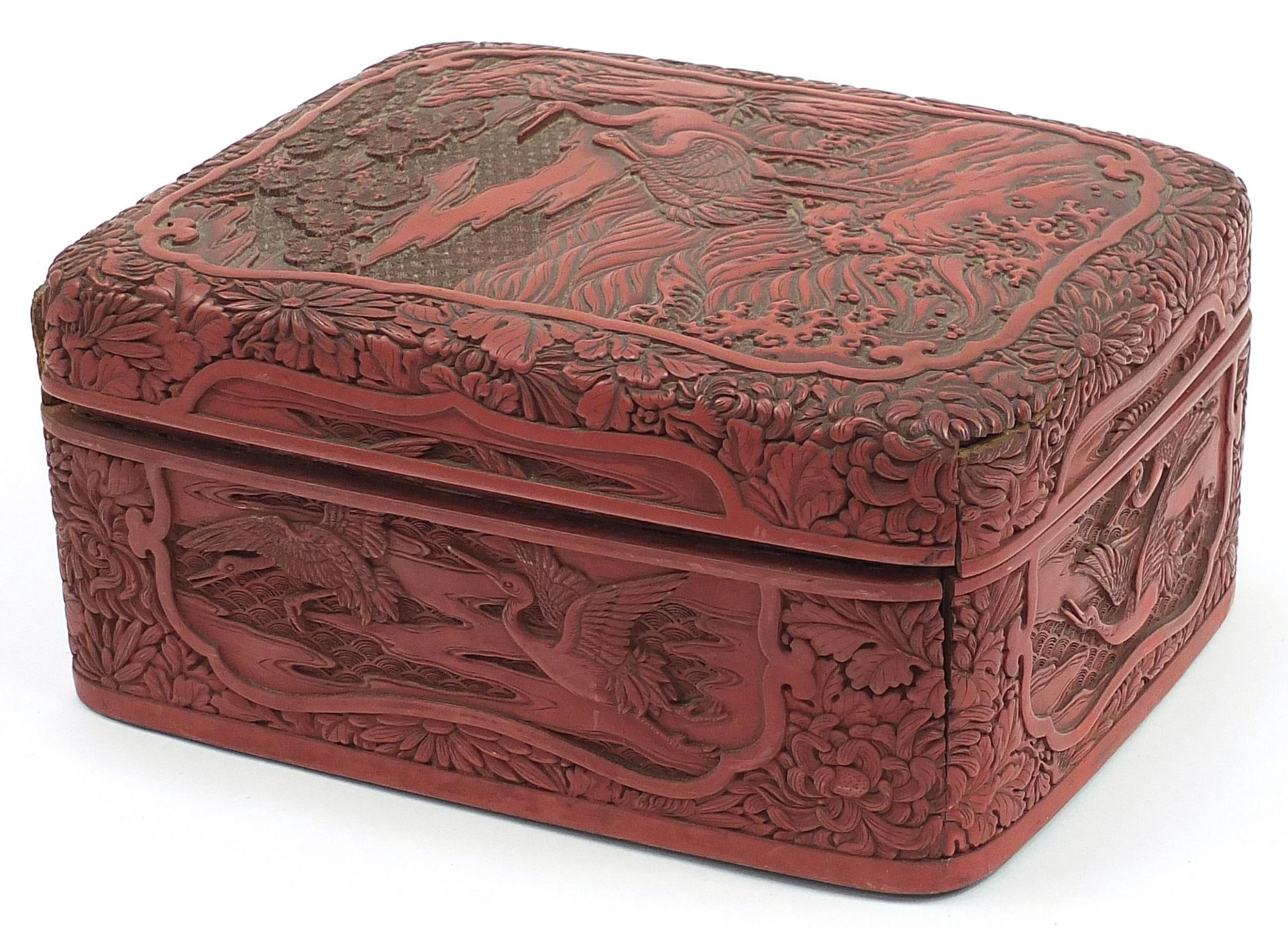 Large Chinese cinnabar lacquer box and cover carved with cranes in a landscape, 12cm H x 27.5cm W