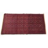 Rectangular Persian red and blue ground rug having an all over geometric design, 172cm x 82cm