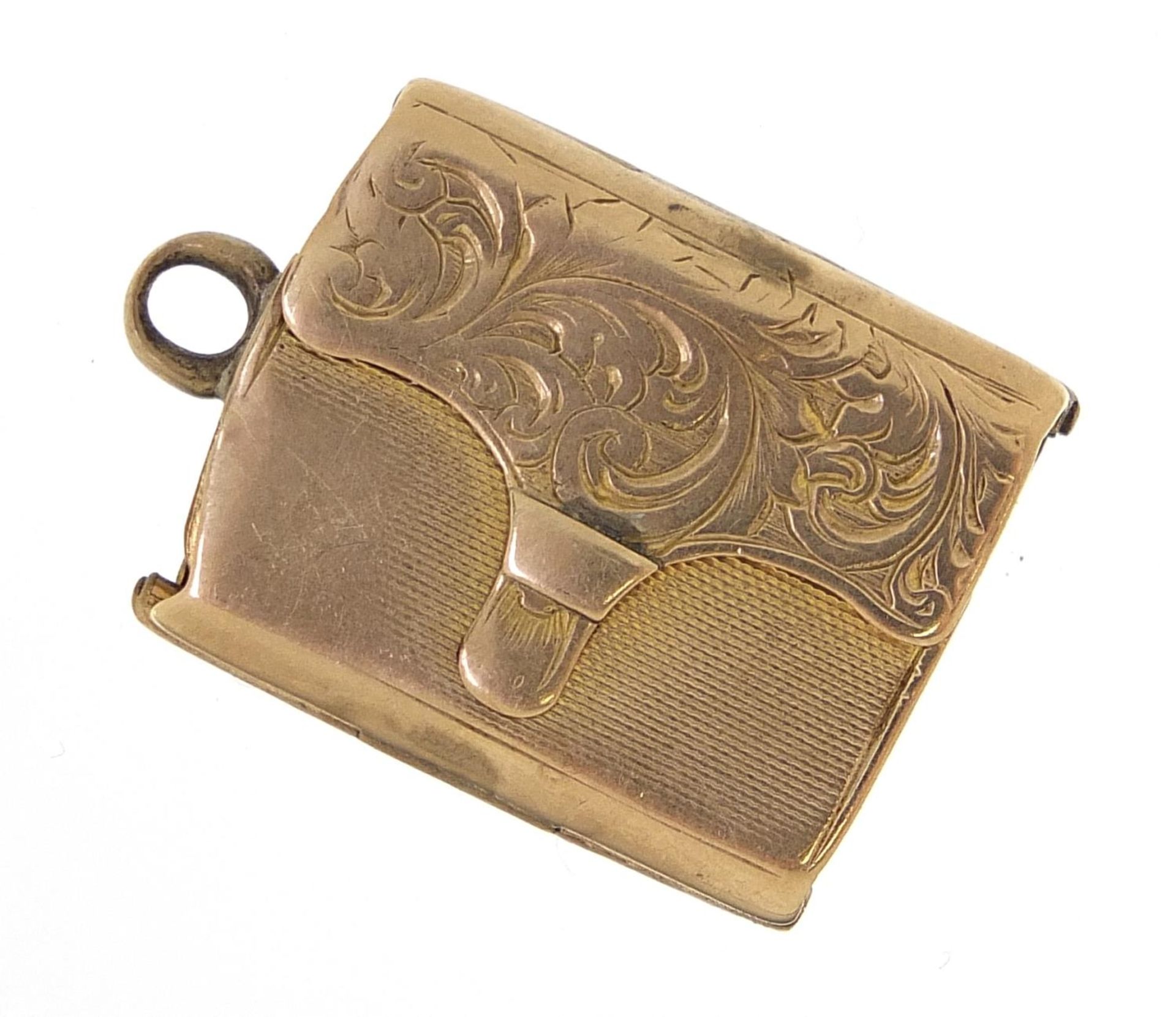 Antique unmarked gold locket in the form of a purse, engraved with flowers, (tests as 9ct gold)