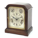 Antique mahogany mantle clock with Westminster chime striking on five gongs, and silvered dial,