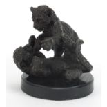 Bronzed study of two leopard cubs playing, raised on a circular ebonised base, 14cm high