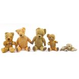 Four antique golden teddy bears with jointed limbs and a tiger, possibly Steiff, the largest 41cm