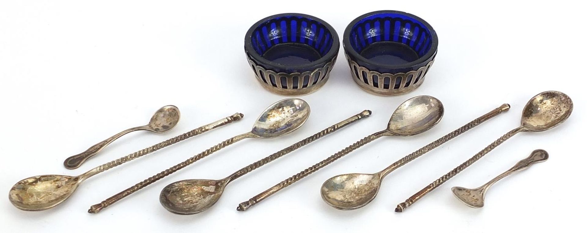 Pair of sterling silver open salts with blue glass liners and spoons and a set of six 800 grade