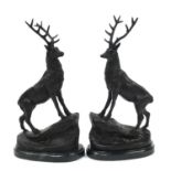 Pair of patinated bronze stags raised on shaped marble bases, each 38.5cm high