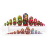 Four Russian Matryoshka hand painted stacking dolls, the largest 21cm high