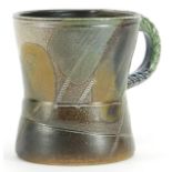 Jane Hamlyn, studio pottery mug having a salt glaze with incised decoration and impressed mark, 10cm