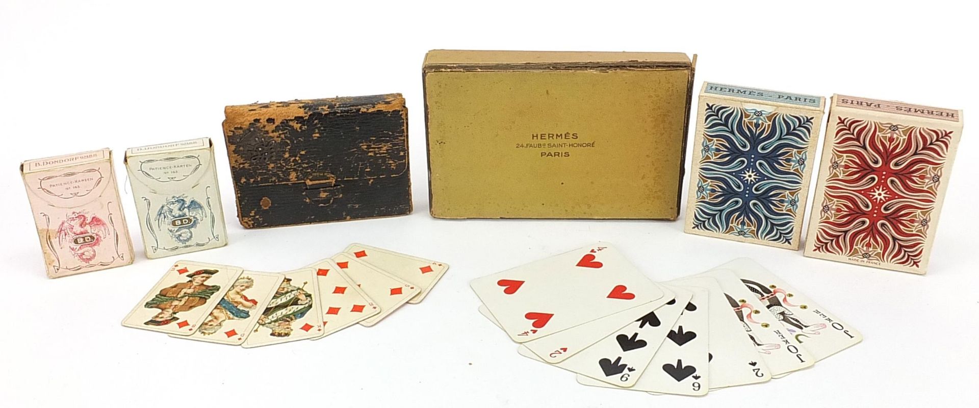 Four packets of vintage playing cards retailed by Hermes Paris and Lovegrove & Flint