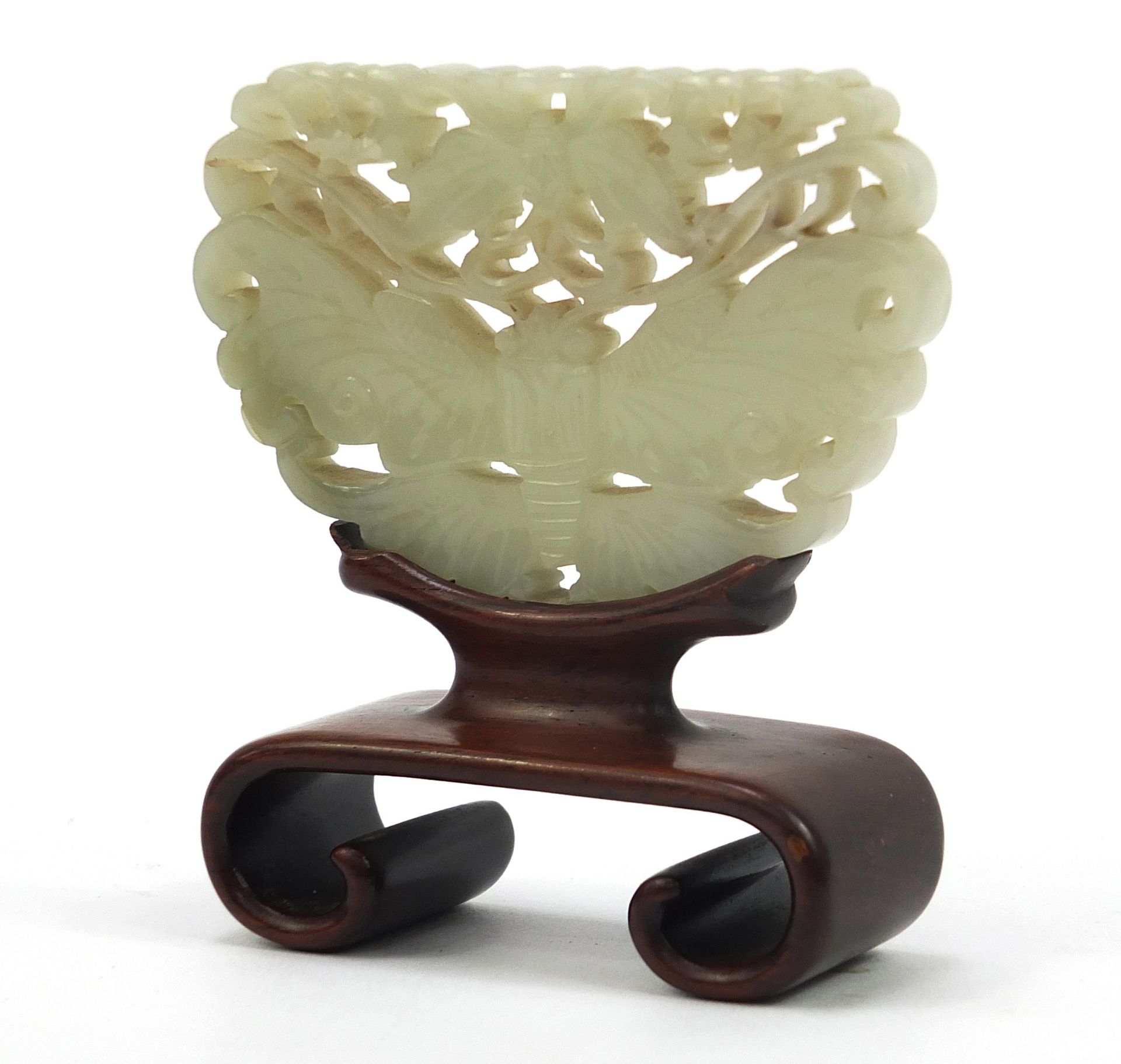 Chinese celadon and russet jade panel carved with two butterflies raised on carved hardwood stand,