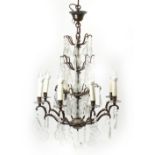 Bronzed eight branch three tier chandelier with cut glass drops, 73cm high excluding the fitting