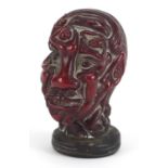 Cherry amber coloured face design seal formed of nude figures with applied white metal mounts,