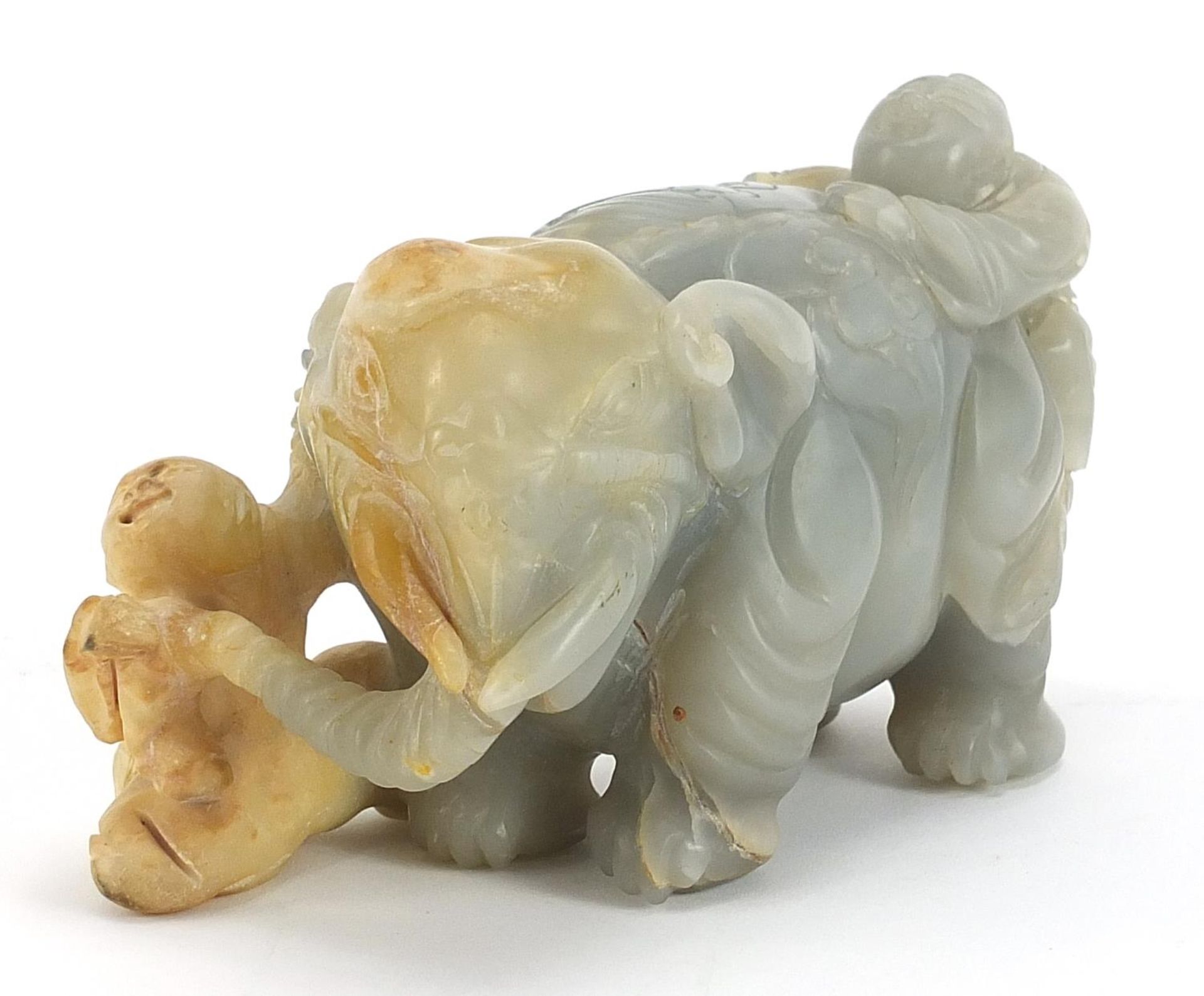 Chinese pale green and russet hardstone carving of two boys and an elephant, possibly jade, 15cm