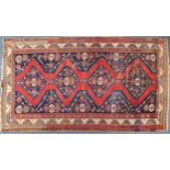 Rectangular red and blue ground rug having an all over geometric design, 320cm x 178cm