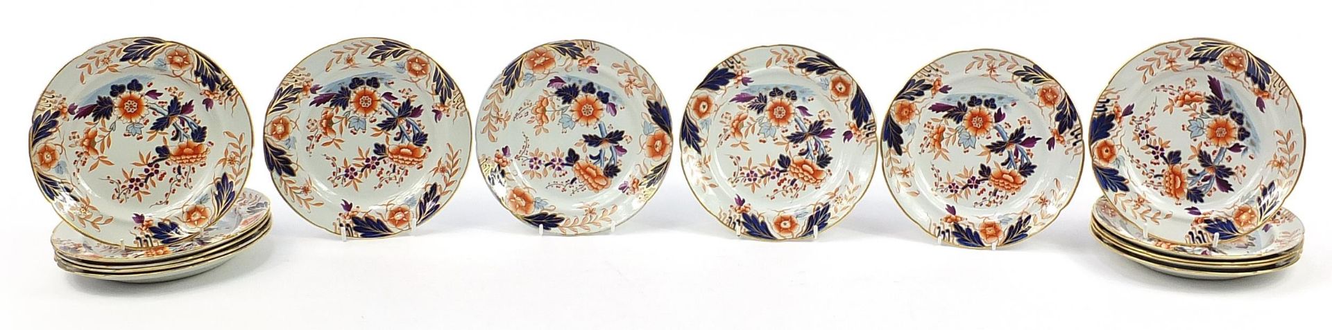 Fourteen Davenport Imari pattern stone china plates hand painted and gilded with flowers, 22cm in