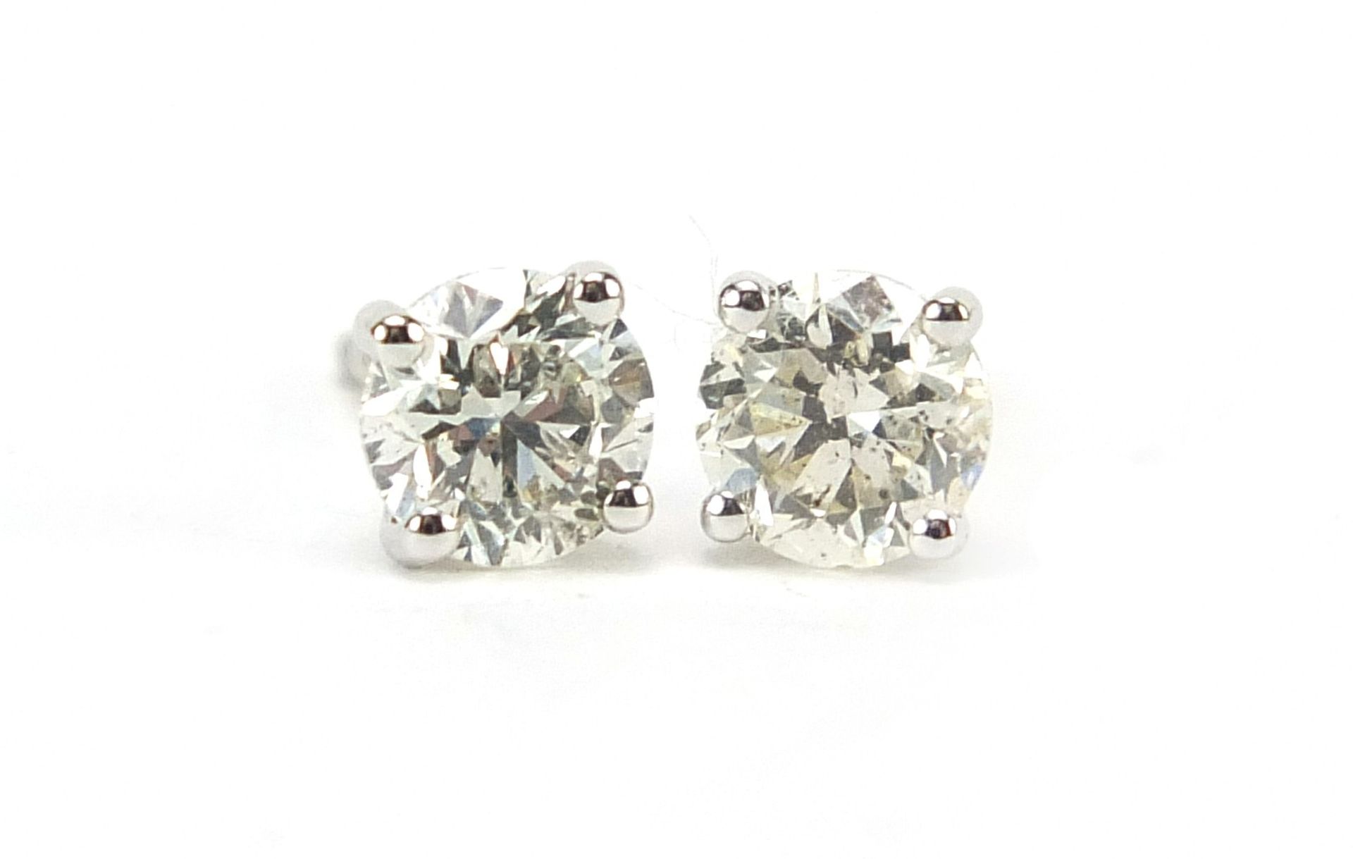 Pair of 18ct white gold diamond solitaire stud earrings, total diamond weight approximately 1.04